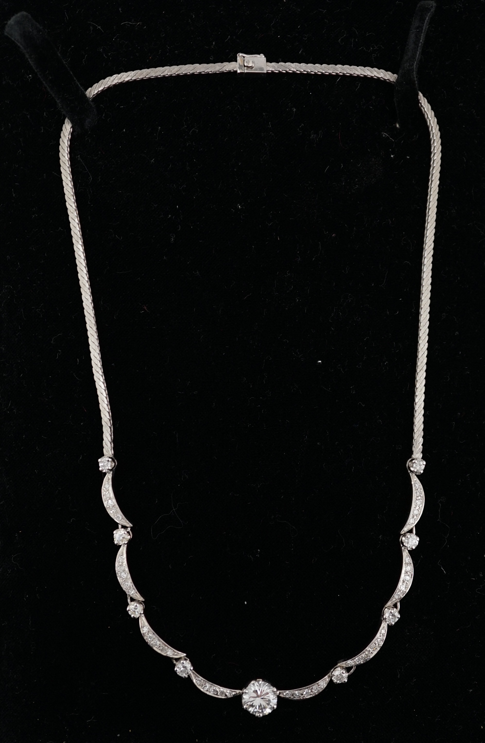 A modern 18ct white gold and diamond cluster set necklace
